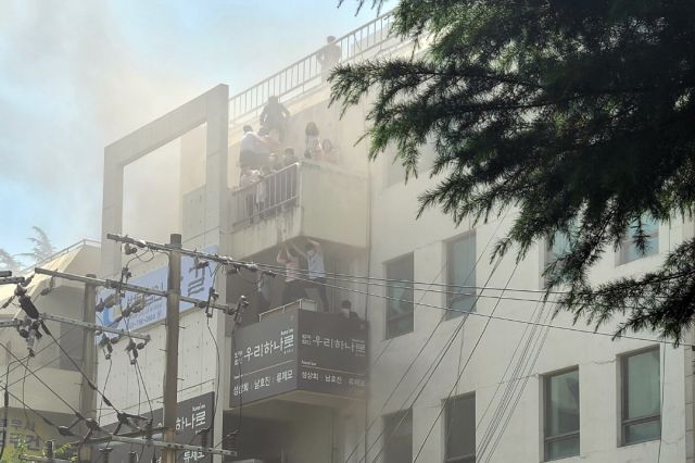 지난 9일 대구 수성구 범어동 대구지방법원 인근 변호사 사무실 빌딩에서 불이나 시민들이 옥상 부근에서 구조를 기다리고 있다. 이 화재로  7명이 숨지고 46명이 다쳤다. 연합뉴스