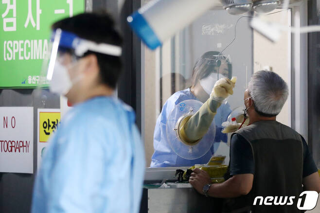 8일 오전 서울 용산구 보건소에 마련된 신종 코로나바이러스 감염증(코로나19) 선별검사소에서 한 시민이 검체 검사를 받고 있다. 2022.8.8/뉴스1 ⓒ News1 민경석 기자
