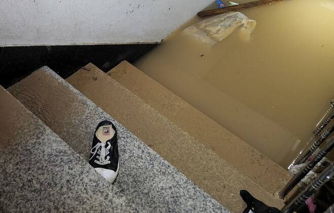 지난 8일 밤 일가족이 수마를 피하지 못해 숨진 서울 관악구 신림동 한 빌라 지하로 들어가는 계단에 9일 오전 9시께 신발 한짝이 놓여 있다. 고병찬 기자.