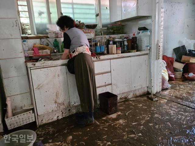서울 관악구 주민 김선심씨가 12일 진흙 범벅인 그릇을 씻고 있다. 원다라 기자