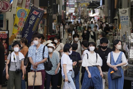 지난달 28일 마스크를 쓴 시민들이 일본 도쿄 상점가를 지나고 있다. AP=연합뉴스