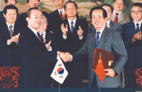1992년 8월24일, 베이징에서 이상옥 외무장관과 첸지천 중국 외교부장이 한ㆍ중 수교 문서를 교환한 뒤 악수를 나누고 있다. [중앙포토]