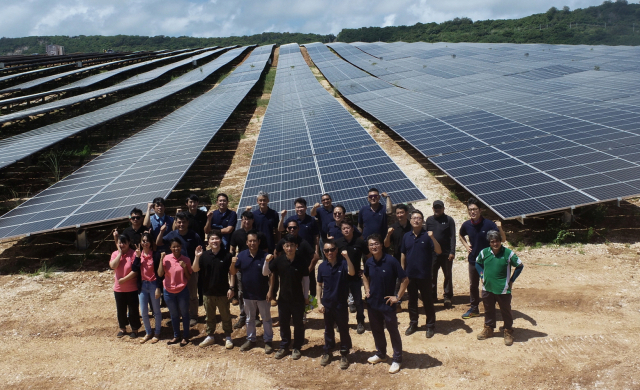 삼성물산 임직원들이 6월 성공적으로 완공한 괌 망길라오 태양광 시설 앞에서 포즈를 취하고 있다. 사진 제공=삼성물산