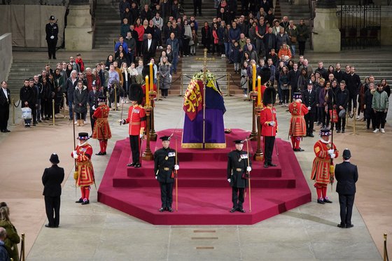 지난 19일(현지시각) 웨스트민스터 홀에 안치된 엘리자베스 2세 영국 여왕의 관을 향해 시민들이 경의를 표하고 있다. 로이터=연합뉴스