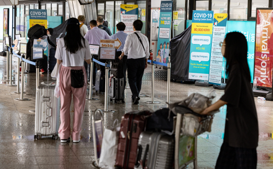 　 : 지난 4일 인천공항을 통해 입국한 외국인 여행객들이 코로나19 검사를 받기 위해 공항 내 검사소에 대기하고 있다. 연합뉴스