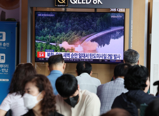 국군의날인 1일 서울역에서 시민들이 북한의 탄도미사일 발사 소식을 텔레비전 뉴스로 시청하고 있다. 연합뉴스