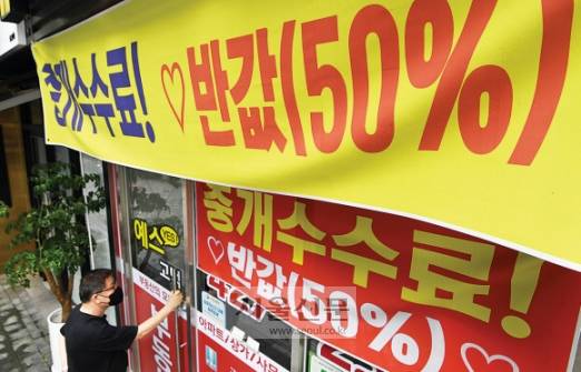 얼어붙은 부동산 시장… ‘반값’ 중개수수료도 나왔다 - 7일 서울 시내의 한 공인중개업소에 중개수수료를 반값만 받겠다는 현수막이 내걸려 있다. 집값 하락 우려 속에 금리 인상과 경기 침체 등의 악재로 매수 심리가 얼어붙으면서 최근 서울을 비롯한 전국 주요 도시의 부동산 거래가 급감하고 있다. 오장환 기자