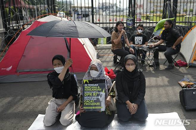 [AP/뉴시스] 6일 인도네시아 국회의사당 앞에서 인권운동가들이 이날 통과 예정의 형법 개혁안을 '여성과 성 소수자 및 종교적 소수파'를 차별하는 법이라고 시위하고 있다
