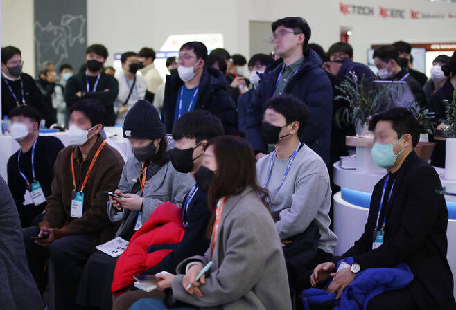 실내 마스크 착용 의무가 해제된 가운데 1일 서울 강남구 코엑스에서 열린 글로벌 반도체 박람회 '세미콘 코리아 2023'에서 관람객들이 마스크를 하고 관계자의 설명을 듣고 있다. 서울=뉴시스