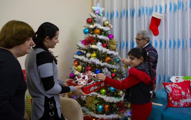 지난해 12월 19일 이라크 바스라에서 한 기독교 가족이 크리스마스를 앞두고 집에 크리스마스트리를 장식하고 있다. 바스라=AP 뉴시스