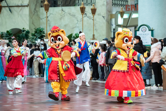 Lotte World's mascots, Lotty and Lorry, perform in a traditional parade. [LOTTE WORLD]