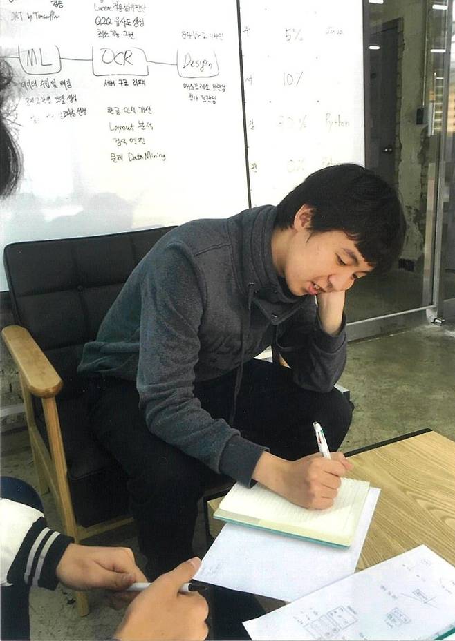 문제를 풀고 있는 정원국 창업자. 뒤의 화이트보드에는 개발중인 'OCR'이 적혀있다. /매스프레소 제공