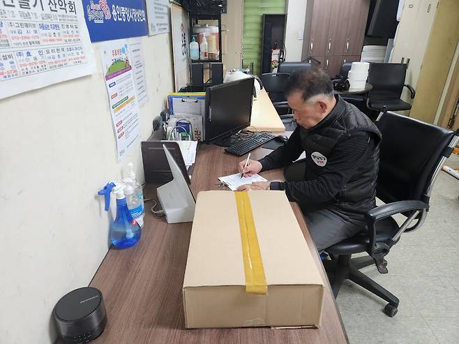 경기 용인중앙시장 배송센터 담당자가 배송품을 접수하고 있다.