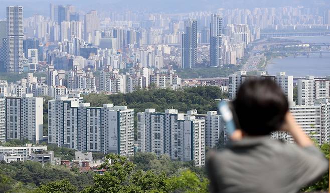 서울 중구 남산 전망대를 찾은 관광객들이 도심 속 아파트 단지를 바라보고 있다. /뉴스1