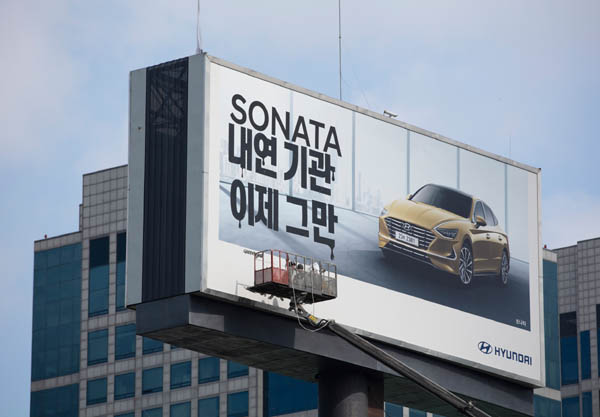 그린피스 액티비스트들이 2019년 9월 15일 서울 현대차 본사 앞에 있는 현대차 광고판에 현대차의 내연기관차 판매 중단을 촉구하는 내용의 스티커를 붙였다. / 그린피스 제공