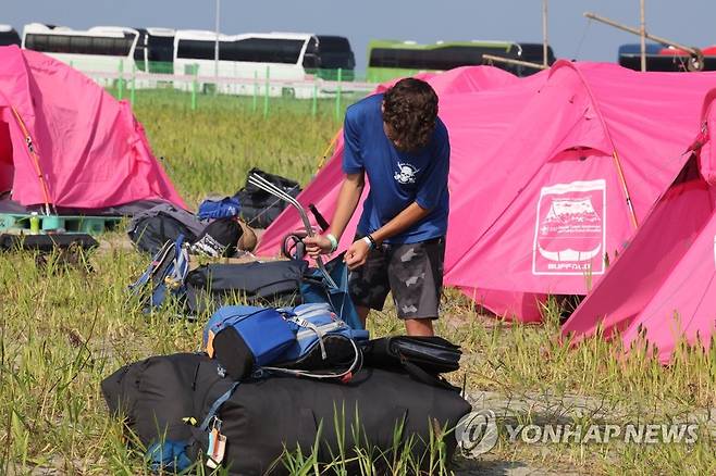 '떠납니다' (부안=연합뉴스) 나보배 기자 = 6일 2023 새만금 세계스카우트잼버리 야영장에서 조기 철수를 선언한 미국 대원과 지도자들이 짐을 꾸리고 있다. 2023.8.6 warm@yna.co.kr