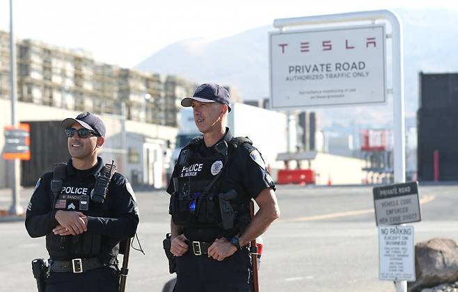 미국 캘리포니아주 프리몬트에서 18일(현지시간) 경찰이 테슬라 제조시설 앞에서 경비를 서고 있다. /AFP