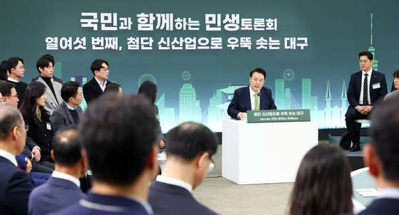 President Yoon Suk Yeol, right, speaks during a public livelihood debate at Kyungpook National University in Daegu on Monday. [JOINT PRESS CORPS]