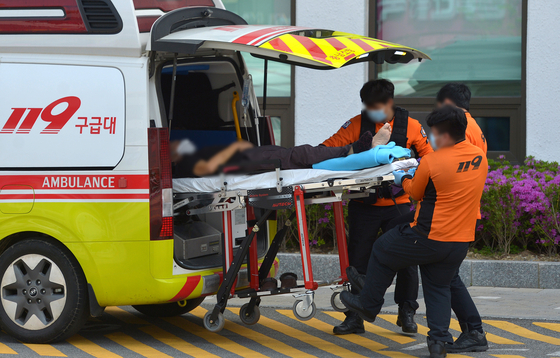 Rescue workers transfer an emergency patient.