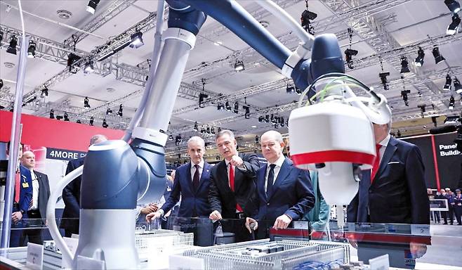 올라프 숄츠 독일 총리(왼쪽 세 번째)와 요나스 가르 스퇴레 노르웨이 총리(왼쪽 첫 번째)가 지난 22일 독일 하노버에서 개막한 하노버메세에서 산업용 장비 제조사 리탈의 마르쿠스 아슈 최고경영자(CEO·왼쪽 두 번째)로부터 로봇을 활용한 최신 산업용 제조 시스템에 대한 설명을 듣고 있다.  /AFP연합뉴스