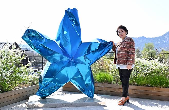 Lee Hyun-sook, founder of the Kukje Gallery, poses for a photo next to "A Star" by Gim Hong-sok at the gallery in Seoul before an interview with The Korea Herald on April 9. (Im Se-jun/The Korea Herald)