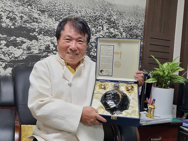 전주이강주 55도 신제품을 출시한 조정형 명인이 금잔 달병 세트를 들어보이고 있다. /박순욱 기자