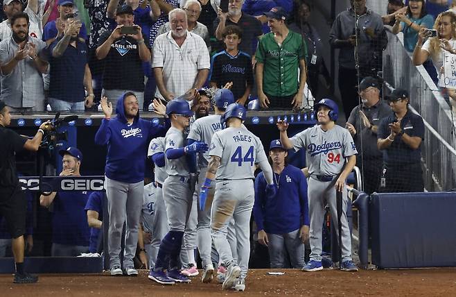 Sep 19, 2024; Miami, Florida, USA; Los Angeles Dodgers greet designated hitter Shohei Ohtani (17) after he hit his 50th home run of the season against the Miami Marlins during the seventh inning at loanDepot Park. Mandatory Credit: Rhona Wise-Imagn Images