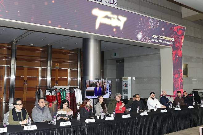The cast and staff of Again 2024 Turandot pose for photos after a press conference at Coex on Dec. 17. (Yonhap)