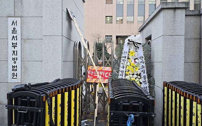 윤석열 대통령의 체포적부심 청구가 기각된 다음 날인 17일 오전 서울서부지법 앞에 ‘탄핵 반대’ 손팻말과 근조화환 등이 놓여 있다. 김가윤 기자