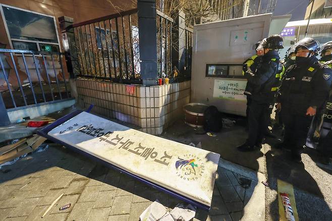 19일 새벽 윤석열 대통령에 대한 구속영장 발부 소식에 격분한 윤 대통령의 지지자들이 서울 마포구 서울서부지방법원에 난입해 훼손한 '서울서부지방법원'이라 쓰인 안내 현판이 바닥에 쓰러져있다./뉴스1