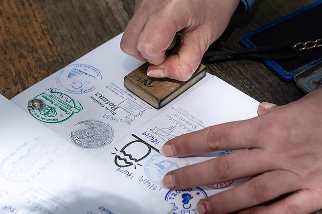 Santiago de Compostela, Spain; April 19, 2019; Pilgrim stamping a identification named The Compostela. It is the accreditation of the pilgrimage to the Tomb of St. James. Camino de Santiago
