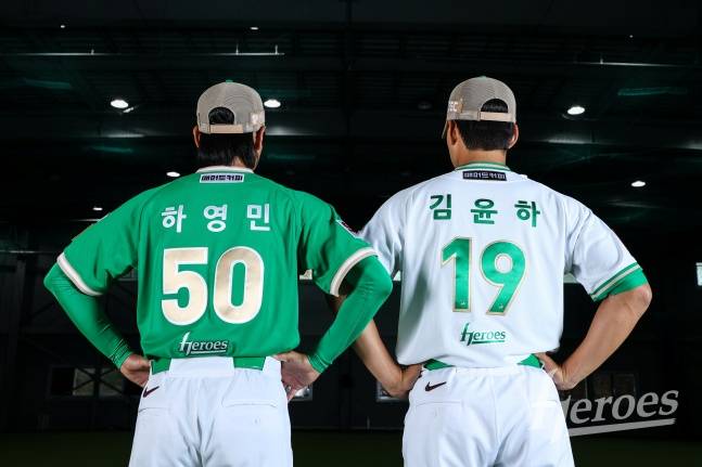 하영민(왼쪽)과 김윤하가 키움의 새 유니폼 '히어로즈 그린'과 '히어로즈 화이트'를 입고 포즈를 취하고 있다. /사진=키움 히어로즈 제공