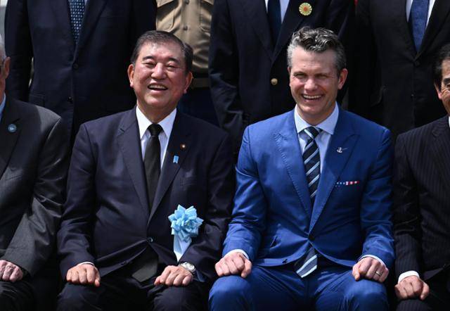 지난달 29일 일본 이오토(이오지마)에서 열린 이오지마 전투 80주년 위령식에서 이시바 시게루 일본 총리(왼쪽)와 피트 헤그세스 미국 국방부장관이 기념촬영을 하며 웃고 있다. EPA 연합뉴스