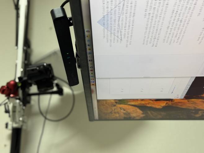 The Eyetech TM5 Mini, a high-precision eye-tracking device mounted beneath the monitor, transforms Jang Ik-seon’s gaze into a fully functional cursor, enabling seamless hands-free control of his computer. (Moon Joon-hyun/The Korea Herald)