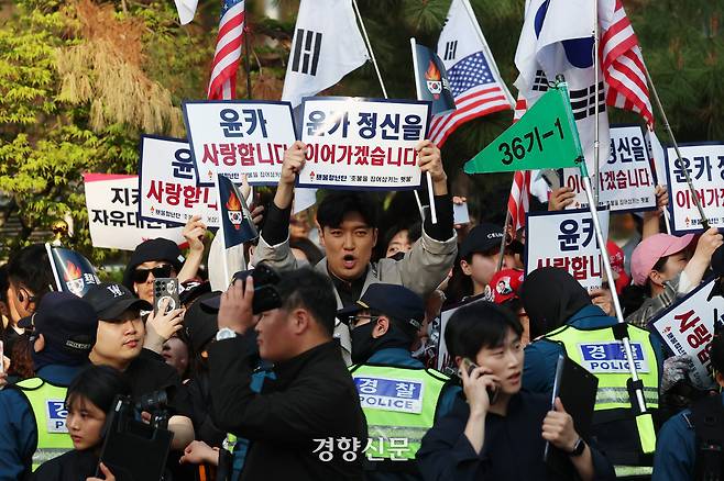 지난 11일 서울 한남동 대통령 관저에서 퇴거한 윤석열 전 대통령이 서울 서초구 자택에 도착하기 전 지지자들이 구호를 외치고 있다. 정효진 기자