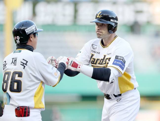 맥브룸(오른쪽)이 적시타를 날리고 윤재국 코치와 하이파이브를 하고 있다. /사진=SSG 랜더스 제공
