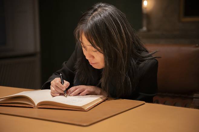 Han Kang signs the Nobel guest book at the Nobel Foundation on Dec. 12. (Nobel Prize Outreach)