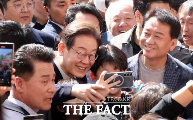 민심을 청취하는 '경청 투어'에 나선 이재명 더불어민주당 대선후보가 4일 강원 영월서부시장에서 어린이와 셀카를 찍고 있다. /영월=뉴시스