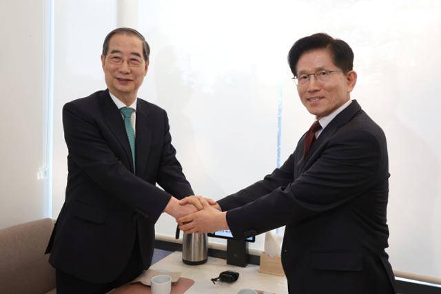 한덕수(왼쪽) 전 국무총리와 김문수 국민의힘 대선 후보가 7일 서울 종로구 한 음식점에서 단일화 논의 전 악수를 하고 있다. 고영권 기자