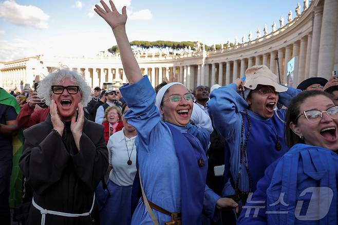 8일(현지시간) 바티칸 시스티나 성당 굴뚝에서 콘클라베가 열린지 이틀 만에 흰 연기가 피어올라 새 교황이 선출됐음을 알리자 가톨릭 성직자들이 기뻐하고 있다. ⓒ 로이터=뉴스1 ⓒ News1 포토공용 기자