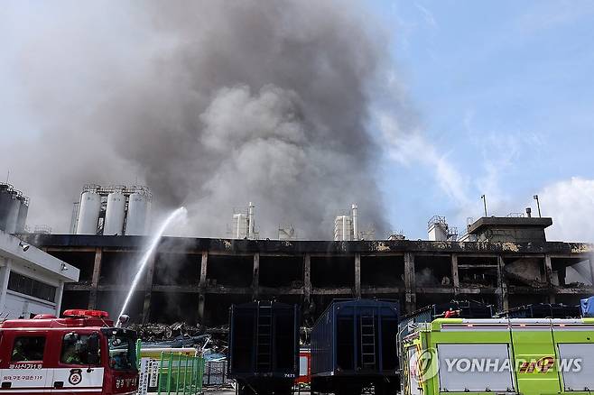 멈추지 않는 연기 (광주=연합뉴스) 김혜인 기자 = 금호타이어 광주공장 화재 발생 이틀째인 18일 불이 난 2공장에서 연기가 나는 가운데 소방대원들이 물줄기를 쏘며 진화 작업을 벌이고 있다. 2025.5.18 in@yna.co.kr