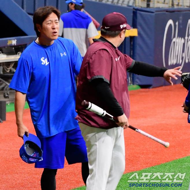 절룩거리며 그라운드에 나온 강민호의 표정이 울상이었다. 키움 박도현 배터리 코치가 강민호가 다쳤을 때 상황을 물어보고 있다.
