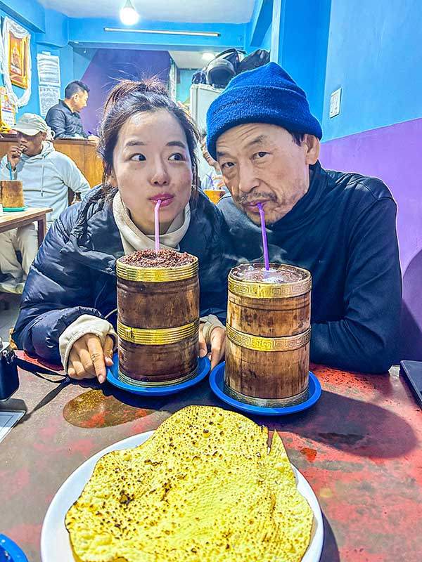 네팔 히말라야 지역에서 즐기는 전통 발효주 통바를 마시고 있는 아빠와 나.