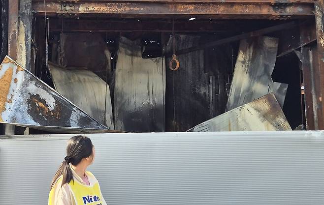 고공농성 500일을 열흘 앞둔 2025년 5월11일, 박정혜씨가 불탄 공장 안을 바라보고 있다. 신다은 기자