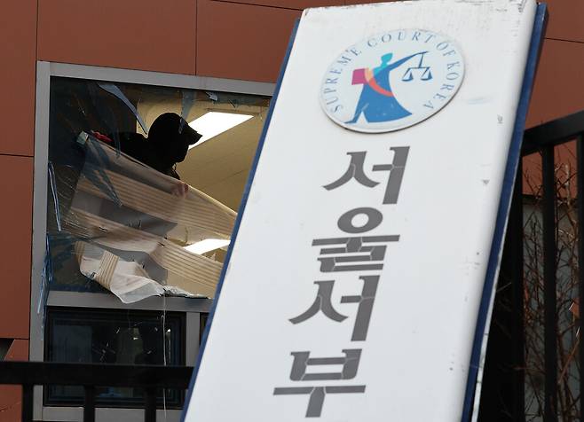 윤석열 당시 대통령의 구속 소식을 들은 일부 지지자들이 서울 마포구 서울서부지방법원에 침입했던 1월19일 서울서부지법 내에서 한 작업자가 복구 작업을 하고 있다. ⓒ연합뉴스