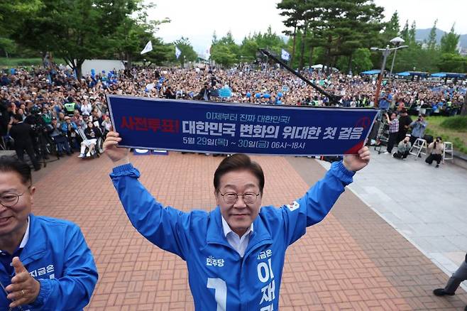 이재명 더불어민주당 대통령 후보가 지난 22일 경남 양산시 양산워터파크공원에서 열린 유세에서 '사전투표! 대한민국 변화의 위대한 첫 걸음'이라고 적힌 현수막을 들어보이고 있다. /사진=뉴스1