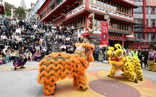 지난 4월 인천 중구 개항동 차이나타운에서 진행된 사자춤 공연을 관광객들이 관람하고 있다. /뉴시스