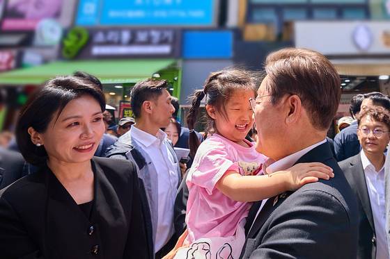 이재명 대통령과 김혜경 여사가 6일 서울 동작구 남성시장을 방문해 어린이 등 시민들과 인사하고 있다. 〈사진=대통령실 제공〉