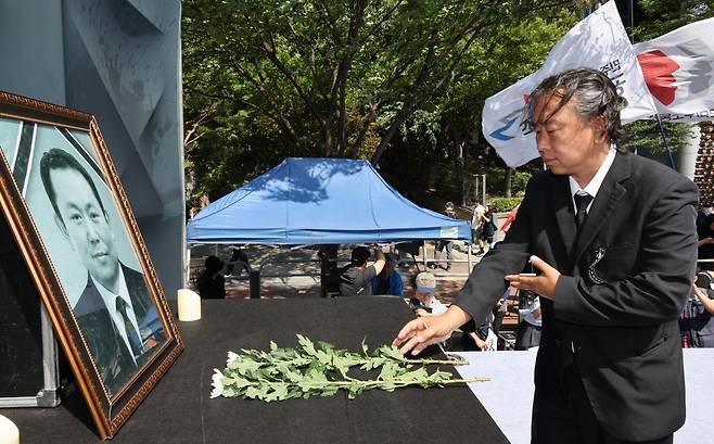 6일 서울역 부근에서 '태안화력 김충현 비정규직 노동자 사망사고 대책위원회'가 주최한 추모문화제에서 참석자들이 고인 영정 앞에 헌화하고 있다. 연합뉴스