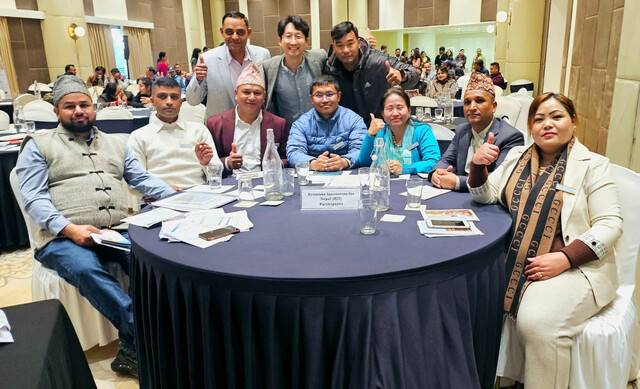 한국에서 교육을 받고 본국으로 돌아간 외국인 노동자들이 지난 1월 네팔에서 열린 사업 설명회에서 황 대표(뒷줄 가운데)와 기념 촬영하는 모습. 더 브릿지 제공